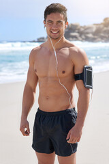 Canvas Print - Happy man, portrait and beach with earphones for fitness, exercise or listening to music in nature. Muscular male person or young runner with smile for workout or outdoor training by ocean coast