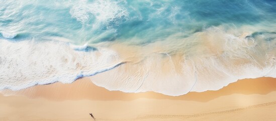Wall Mural - A captivating aerial view showcasing a stunning and tranquil beach with an ethereal ambiance providing ample copy space for an image