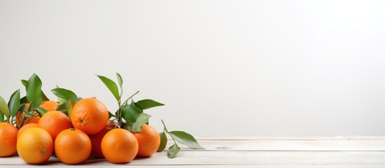 Wall Mural - A copy space image featuring a small arrangement of tangerines placed on a white wooden table