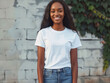 © VISUAL BACKGROUND - A young black woman in jeans and white t - shirt is smiling.
