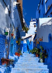 Wall Mural - narrow alley leads through the historic city center of the blue city of Chefchaouen in northern Morocco