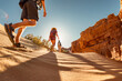 © cppzone - Group of tourists with small backpacks walks in sunset desert