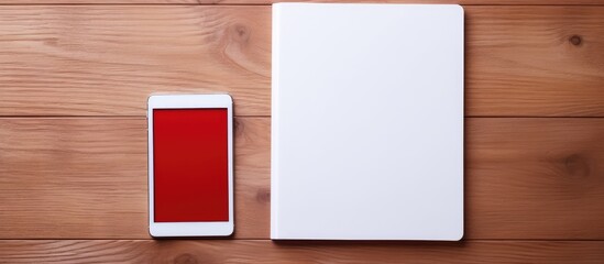 Aufkleber - Red notebook and white tablet on a table with a wooden texture. copy space available