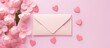 © Gular - A lovely Valentine s Day concept with pink flowers an envelope and hearts on a pastel pink background The image is taken from a top view and offers plenty of copy space