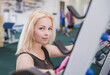 © Виктор Осипенко - Attractive blonde stands near squat frame in gym