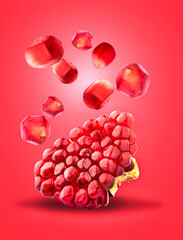 Wall Mural - Cut the pomegranate   isolated on red background. Levitation.