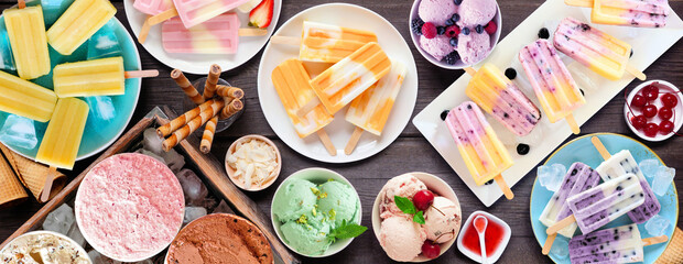 Poster - Cool summer food table scene. Group of refreshing ice cream, popsicle and frozen treats. Top view on a dark wood banner background.