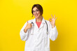 © luismolinero - Doctor woman isolated on yellow background showing ok sign and thumb up gesture