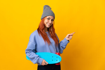 Wall Mural - Teenager Russian skater girl isolated on yellow background pointing finger to the side