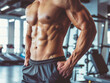 © Tanuha - Athletic male torso showing muscles, abs in fitness center.