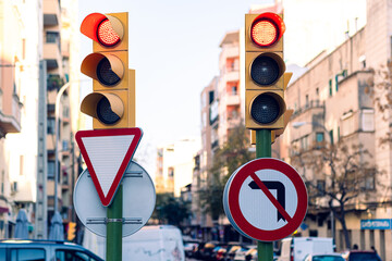 Traffic lights on the street of Palma de Mallorca. Yellow traffic lights and road signs