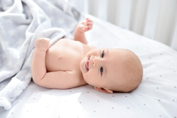 Canvas Print - Cute little baby lying in crib at home