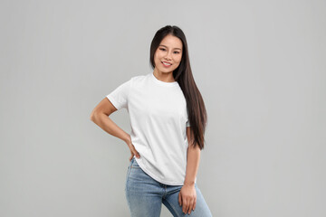 Poster - Woman wearing white t-shirt on light grey background
