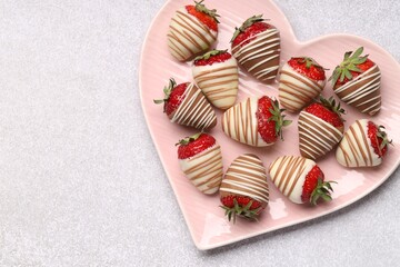 Sticker - Heart shaped plate with delicious chocolate covered strawberries on light table, top view. Space for text