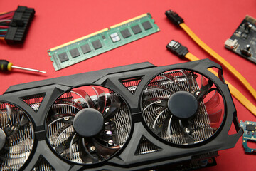 Poster - Graphics card and other computer hardware on red background, closeup