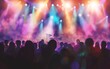 © OLGA - Silhouetted concert crowd against vibrant stage lights.