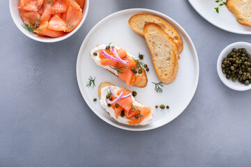 Wall Mural - Making bruschetta with cream cheese, smoked salmon with toast and capers