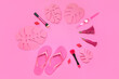 © Pixel-Shot - Frame made of female accessories, flip-flops and paper palm leaves on pink background
