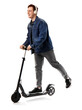 © Pixel-Shot - Young man in headphones riding modern electric kick scooter on white background