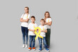 © Pixel-Shot - Group of kids with yellow ribbons on grey background. International Childhood Cancer Day