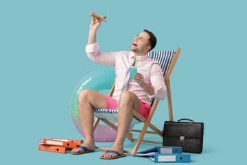 Poster - Happy male office worker sitting on deckchair with cocktail and toy plane on blue background. Summer vacation concept