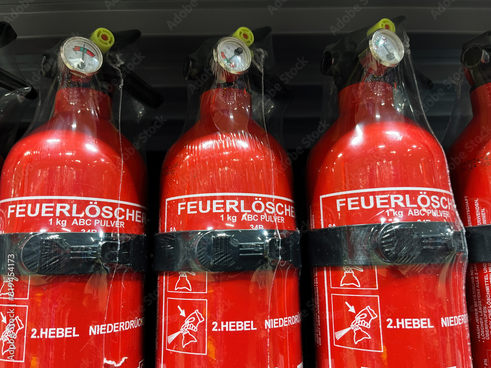 Red Fire Extinguishers on Store Shelf Stock Photo | Adobe Stock