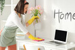 © Pixel-Shot - Young woman cleaning table with laptop at home
