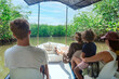 © Brocreative - View from behind of a Family on a wildlife estuary boat tour in Costa Rica. Exploring the Tamarindo estuary and river area looking for wildlife and the mangrove forests. Costa Rican Travel photo
