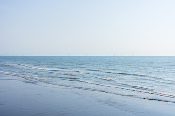 Wall Mural - Seaside with the wind turbine over the ocean