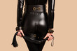 © filins - Beautiful dominant mistress woman in latex catsuit posing with riding crop