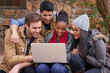 © peopleimages.com - Students, college and education with laptop on campus for communication, learning or knowledge. Discussion, diversity and friends with technology for school project, study group or search internet