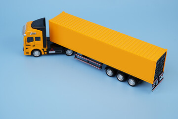 yellow container carrier truck model on blue background. copy space for text.