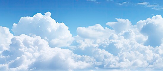 Poster - White clouds drifting in a clear blue sky suitable for a copy space image