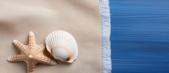 Wall Mural - A seashell on a brown and white napkin background symbolizing a simple summer theme with space for text and celebrating World Ocean Day in a flat lay image. Copy space image