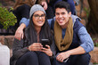 © peopleimages.com - Students, couple and portrait on campus with smile, smartphones and happiness at college. Man, woman and hug at university for bonding, support and care together and sit on steps on school grounds