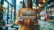 © antkevyv - Presents woman holding cardboard boxes tied with rope symbolizing on-demand delivery service