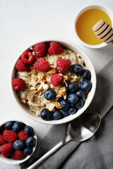 Wall Mural - Porridge with berries, blueberry and raspberry and almond nuts