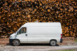 © ADDICTIVE STOCK - White van parked in front of woodpile in the Alps
