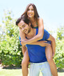 © peopleimages.com - Couple, piggy back and outside happy for relationship, bonding love and care in nature date for romance. Blue sky, trees and summer holiday with affection, caring and support with playful people