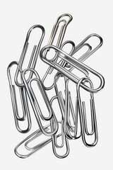 Aufkleber - A collection of silver paper clips on a clean white background. Perfect for office or school related designs
