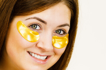 Wall Mural - Woman with gold patches under eyes