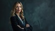 © AlfaSmart - Businesswoman in a power suit, looking directly at the camera against a dark backdrop