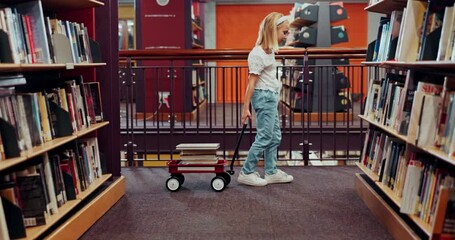 Canvas Print - Library, kid and girl on search for books, growth and development of child, literature and knowledge. Bookshelf, youth and information in novel, story and wagon for reading for school and learning