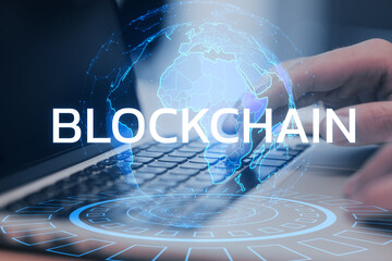 Poster - Fingers typing on a laptop with BLOCKCHAIN text and digital world map hologram, symbolizing technology and connectivity on a blue-toned background