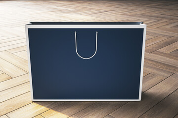 Poster - A mockup of a dark blue paper shopping bag with handles, standing on a herringbone wood floor, with ample copyspace for branding and logos. 3D Rendering