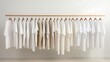 © Pakorn - Clothing rack with white sweatshirts, minimalist style, close up, focus on the fabric, theme of elegance, dynamic, blend mode, backdrop of retail environment