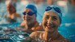 © Photolife   - happy pensioners in the pool swim and look at the camera smiling. active leisure and sports activities for pensioners. therapeutic swimming for the elderly