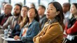 © Wattana - A focused audience of diverse professionals attentively listening to an Asian woman presenting her findings on sustainable architecture.