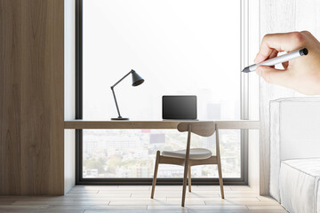 Aufkleber - Hand drawing on a minimalist desk setup with laptop, black lamp, and city view. Creative workspace concept
