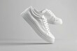 © Ева Поликарпова - White sneakers on a grey background, suitable for fashion and lifestyle concepts